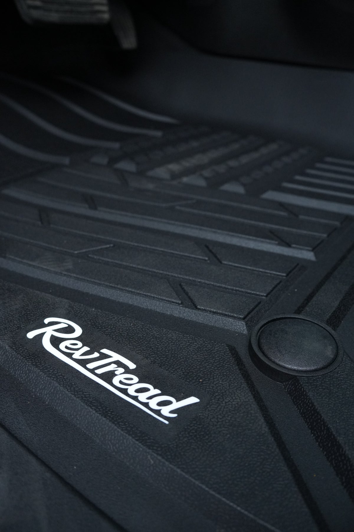 RevTread script logo on a black textured floor mat