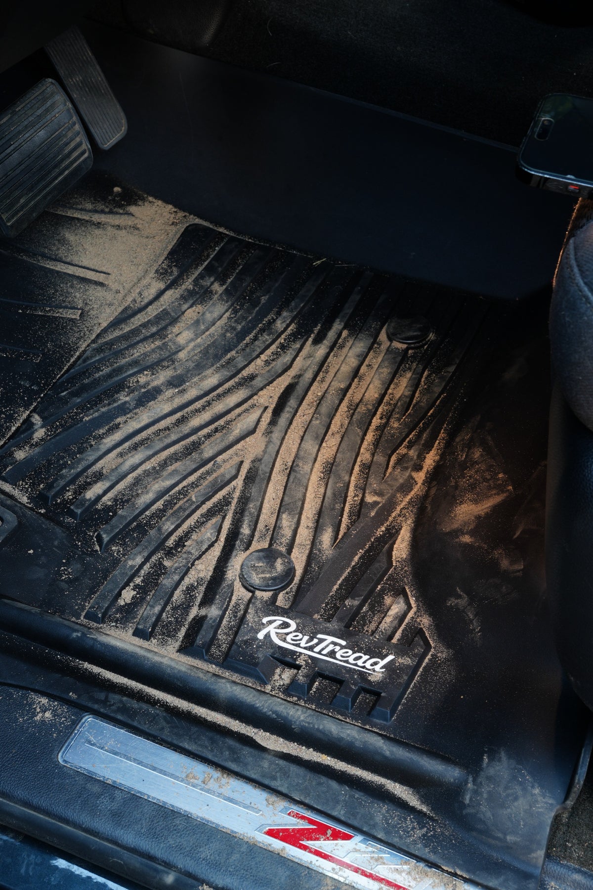 Sand and dirt trapped on a RevTread floor mat in a Chevy Silverado Z71
