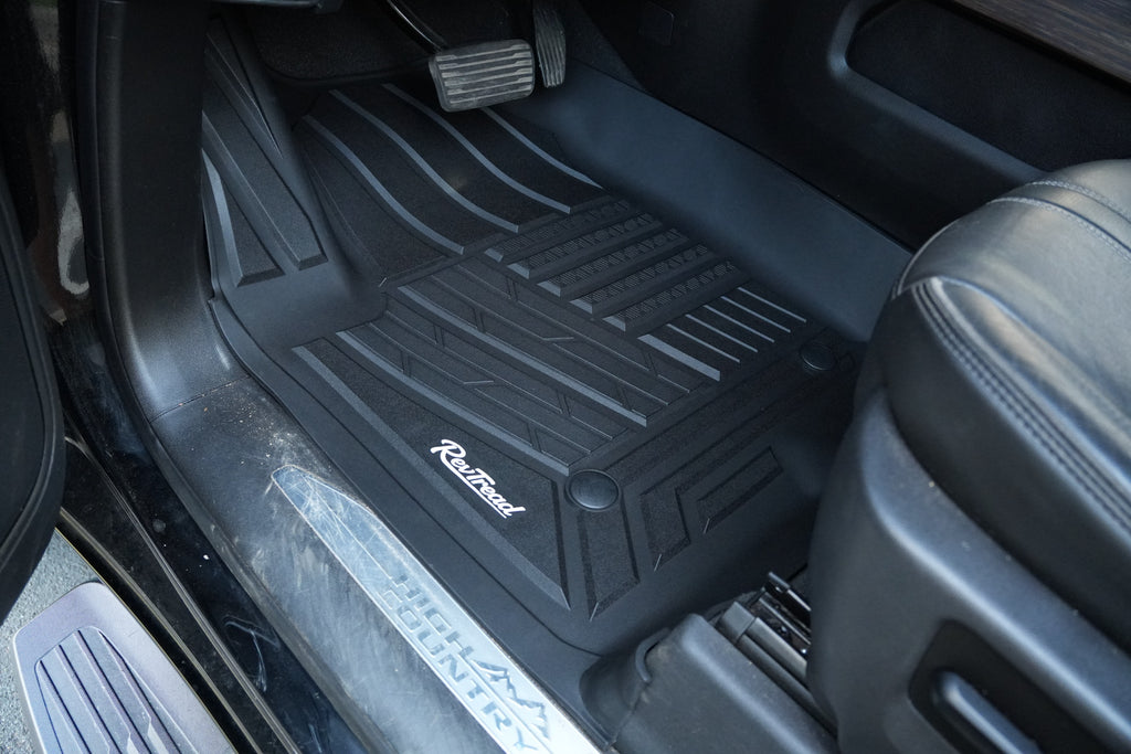 RevTread driver floor mat showing edge-to-edge fit along the door sill of a GMC Sierra