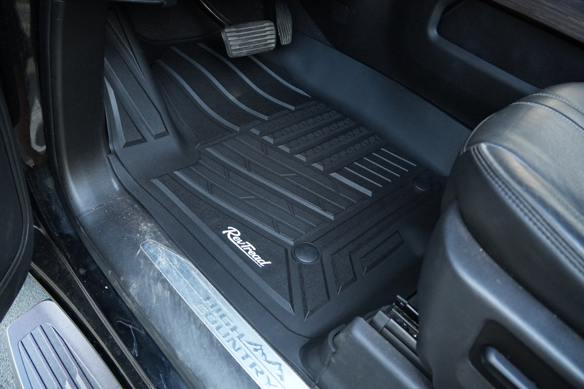 RevTread driver floor mat showing edge-to-edge fit along the door sill of a GMC Sierra