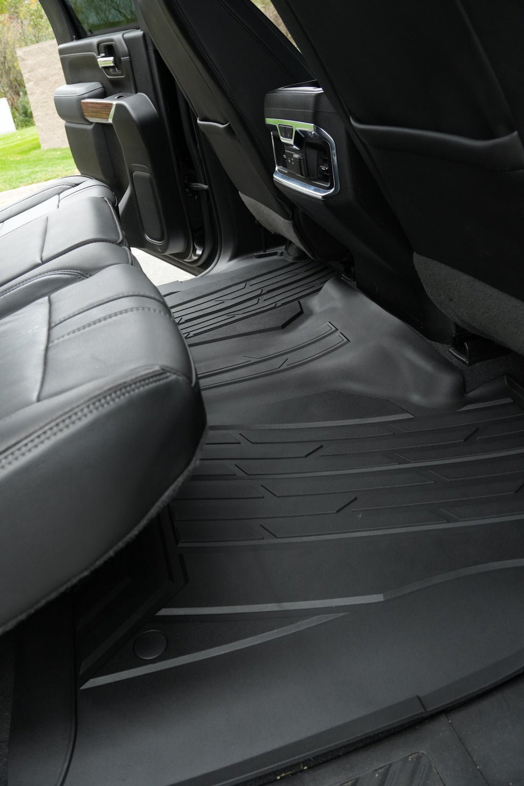 RevTread rear floor mat installed under the second-row seats of a Silverado/Sierra