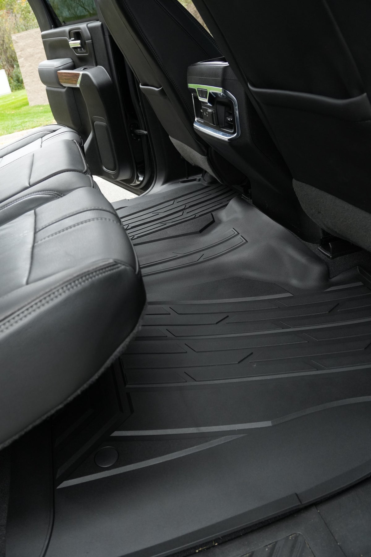 RevTread rear floor mat installed under the second-row seats of a Silverado/Sierra